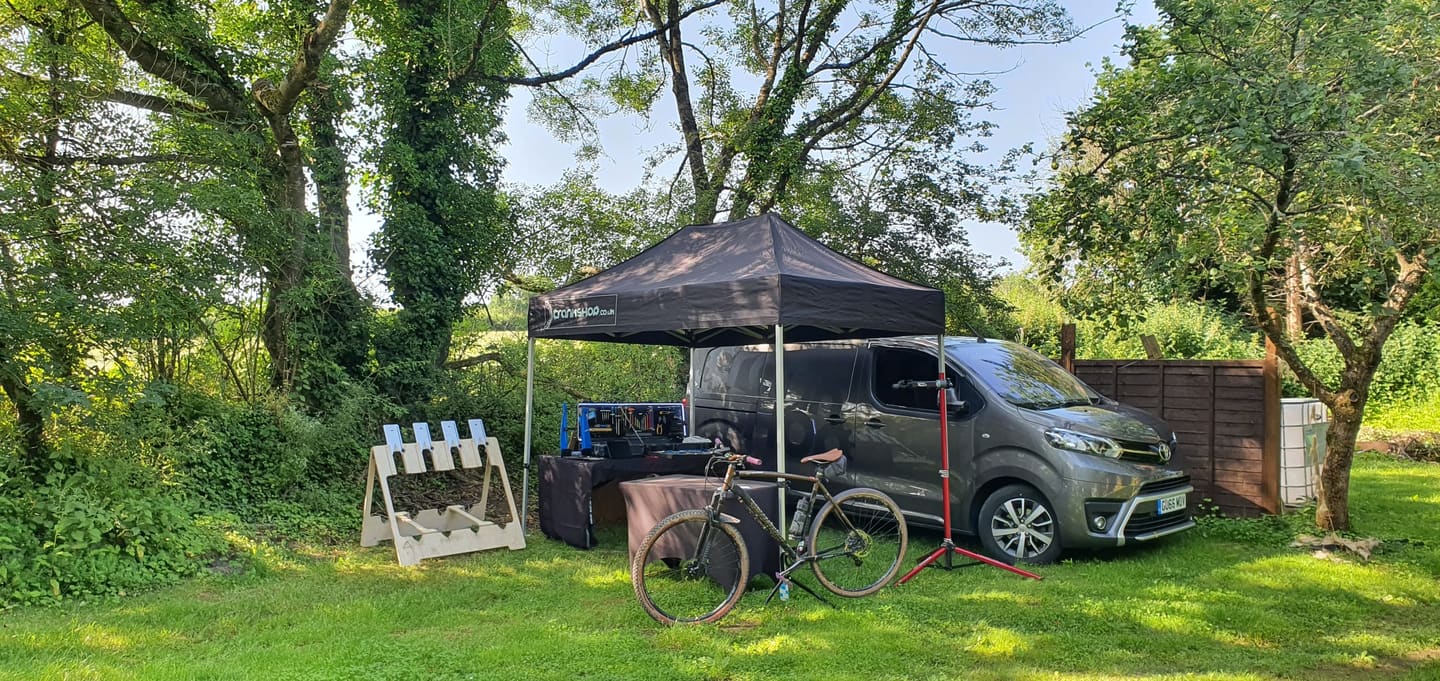The CrankShop gazebo and van set up as a static workshop at an event