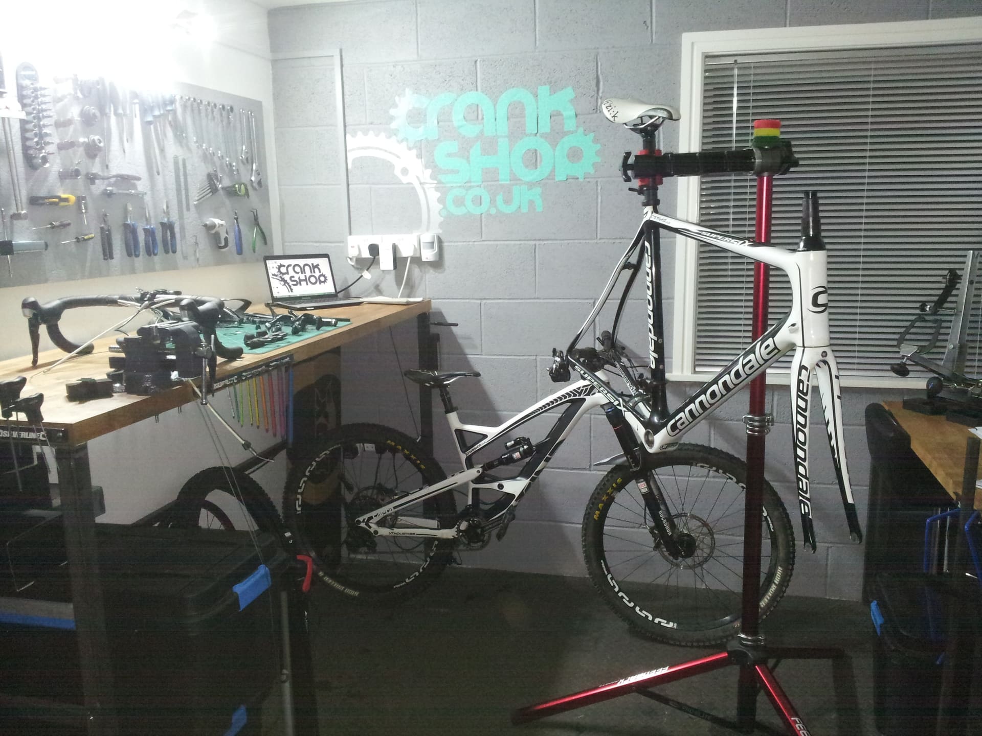 A road bike on the workstand in the CrankShop workshop